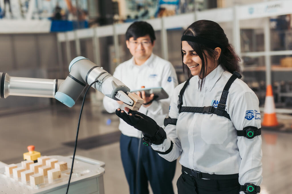 Two people using machinery